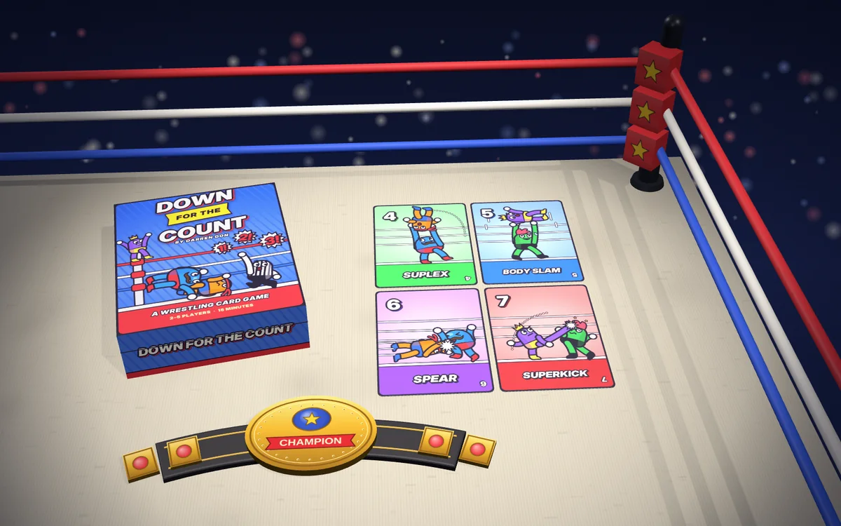 Down for the Count mockup in a wrestling ring: the box, the Suplex, Body Slam, Spear and Superkick cards and a championship belt, with the ropes and a corner post behind.