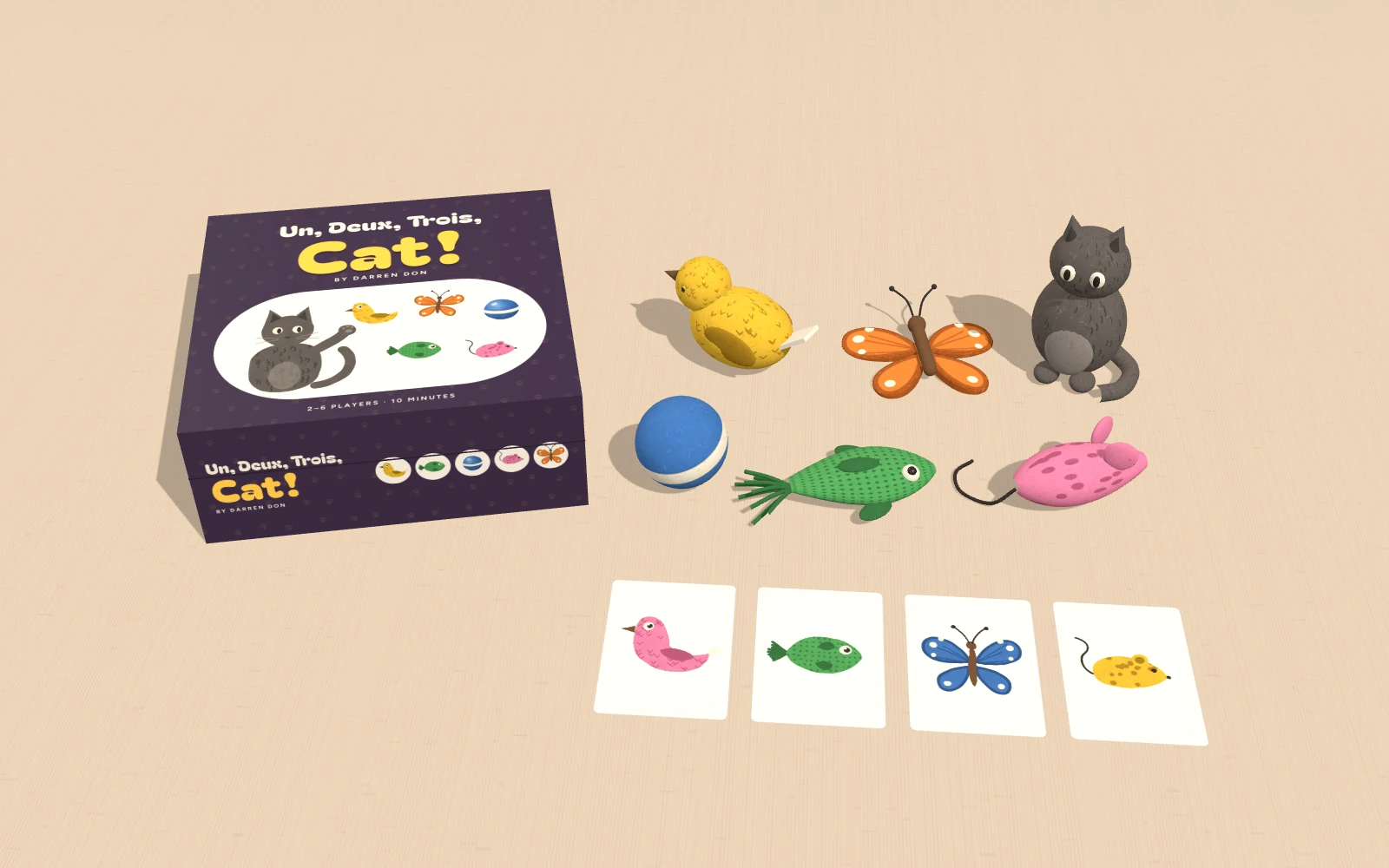 The box beside the five felt toys, the felt cat and four flipped cards.
